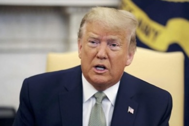 Photo of President Trump wearing a navy blue suit, white shirt, gray tie and a flag pin.