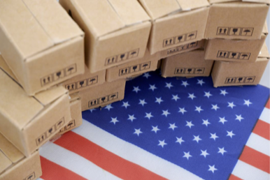 Photos of boxes stacked on top of each other covering an American flag